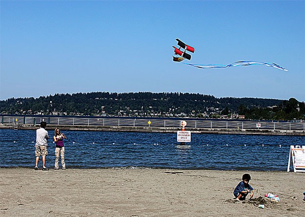 Brad Strong and Jana Flener fly a kite shaped like a pirate ship this past month at Gene Coulon Memorial Beach Park.