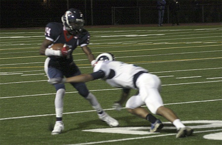 Lindbergh's Diondre Toms pushes a Mount Rainier defender aside after catching a pass in Friday night's 27-7 win.