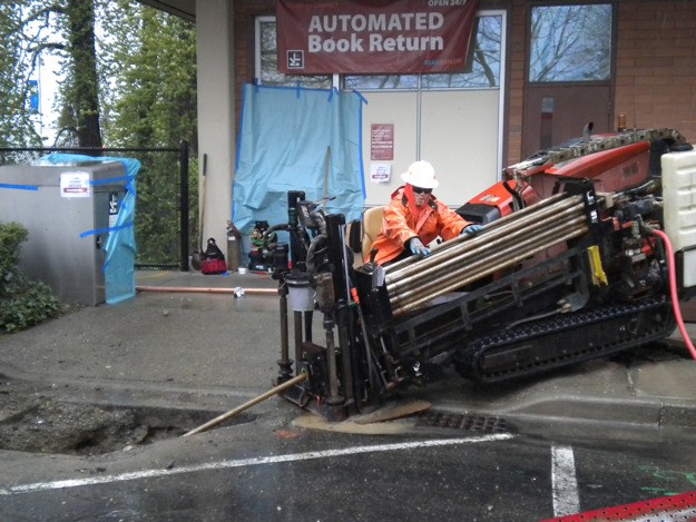 Contractors work to repair a leaky pipe at the Cedar River Library April 10.