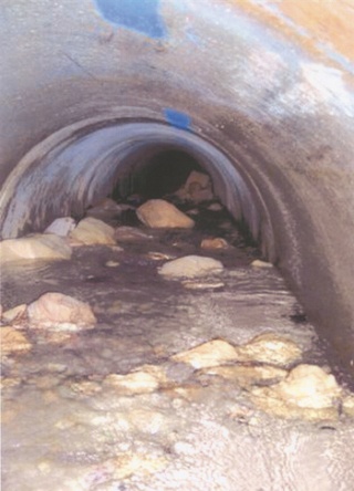 A video camera sent inside the broken culvert late last year under Interstate 405 shows the debris and collapsed material that has filled it inside.