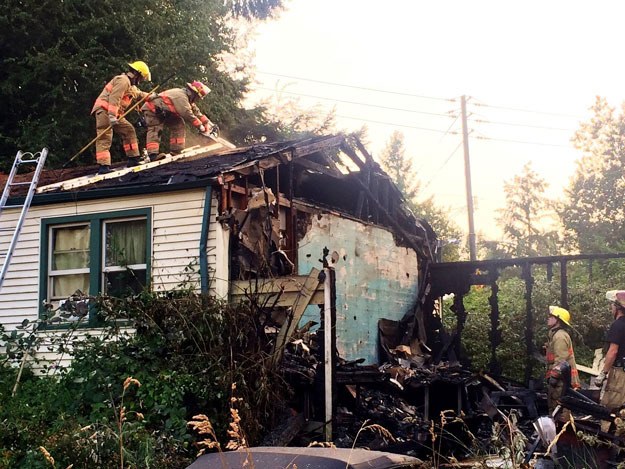 Firefighters work to put out a fire in a garage in Skyway.