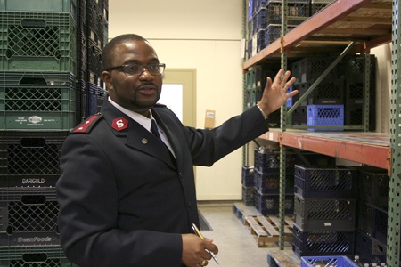 Captain Terry Masango of the Salvation Army Renton points to 'the wall of shame