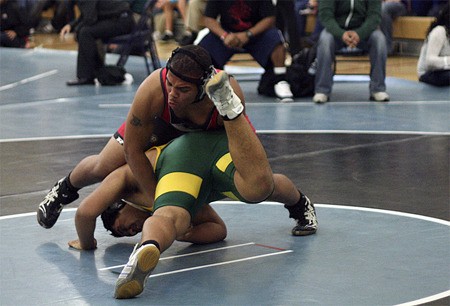 Renton's Joseph Watson wrestling in the first round of the 285-pound bracket at the regional tournament. Watson beat Clover Park's Faavevela Fatalia in this match and lost 3-2 in overtime in the finals. Watson qualified for state next weekend.