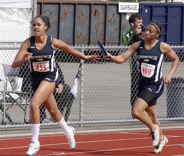 Janayla Scott hands off to Jazzmine Knox during the 4 X 100 relay at the state track and field meet last spring.