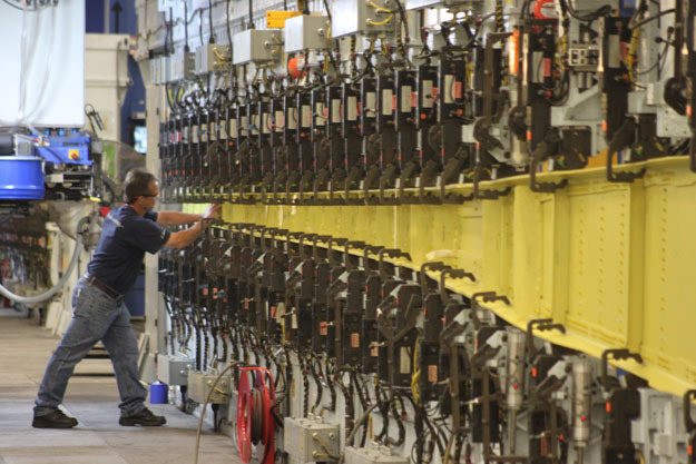 A worker at the Boeing Renton facility works on part of a wing for a 737 MAX