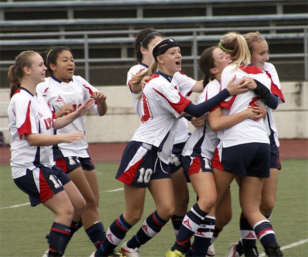 The Lindbergh girls soccer team celebrates after winning a playoff game in a shootout Nov. 6.