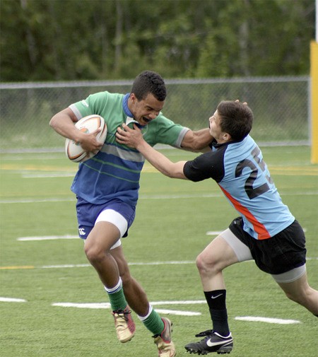 Liberty's Chandler Jenkins stiff-arms a Chuckanut player during the state title game May 22 at Magnuson Park in Seattle.