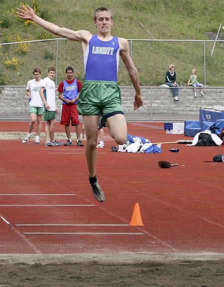 Liberty's Devin Bennett jumps in the long jump at a meet April 29.