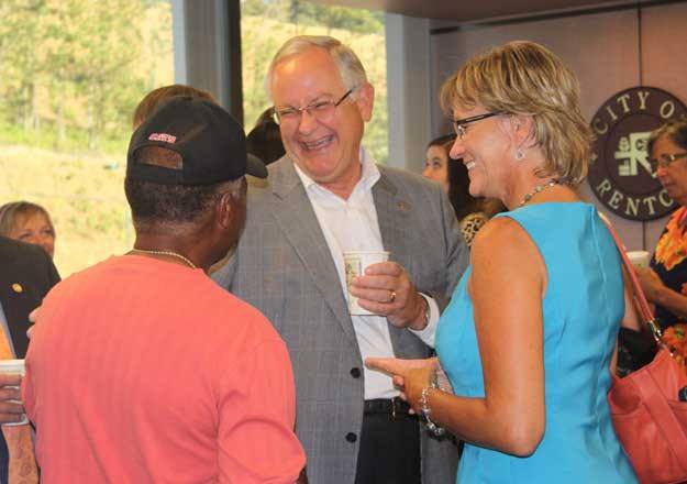 Pastor Kirby Unti shares a laugh with Al Talley and Renton School District Superintendent Merri Rieger during a reception in his honor Aug. 5.