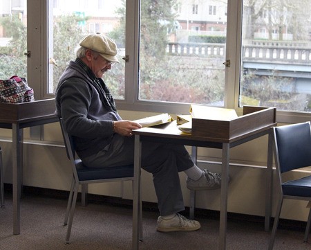 Frank Young reads in the Renton Municipal Library. Feb. 9 the city will vote on whether to annex the library to the King County Library System