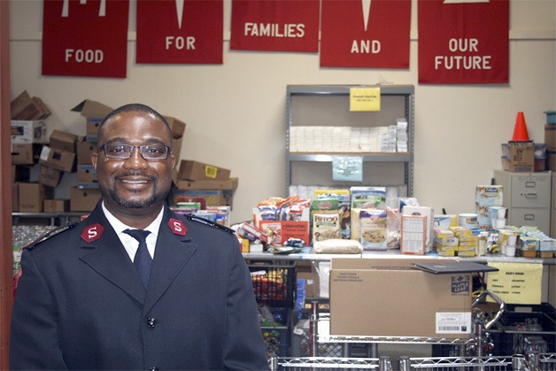 Captain Terry Masango stands in the distribution center of the Salvation Army Renton Rotary Food Bank where food is disributed to about 1