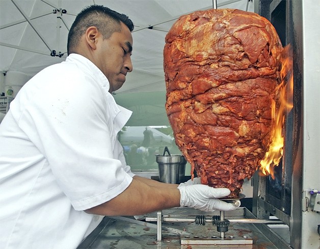 Oscar Mendez of Los Chilagos sets up his rotisserie Tuesday.