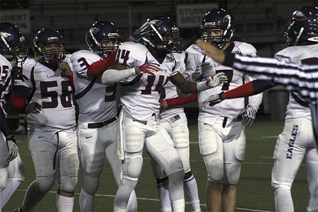 Lindbergh's Diondre Toms celebrates with teammates after an interception against Evergreen.