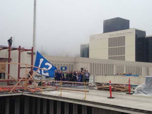 The 12th man flag is raised over Valley Medical Center