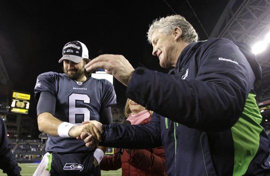 Seahawks coach Pete Carroll and quarterback Charlie Whitehurst celebrate after Seattle's 16-6 win against the Rams Sunday.