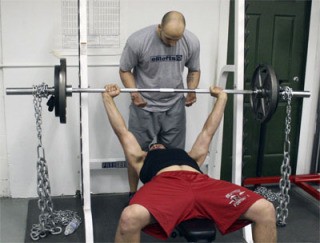 Renton High senior Armin Basic works on the bench press while Luka Hocevar spots him. Hocevar runs Hocevar Performance