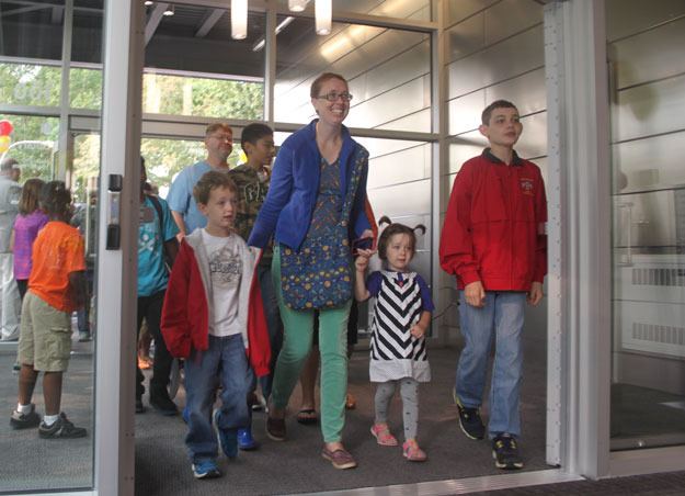 Ruthie Severance and her children were among the first people through the door Saturday at the new Cedar River Library.