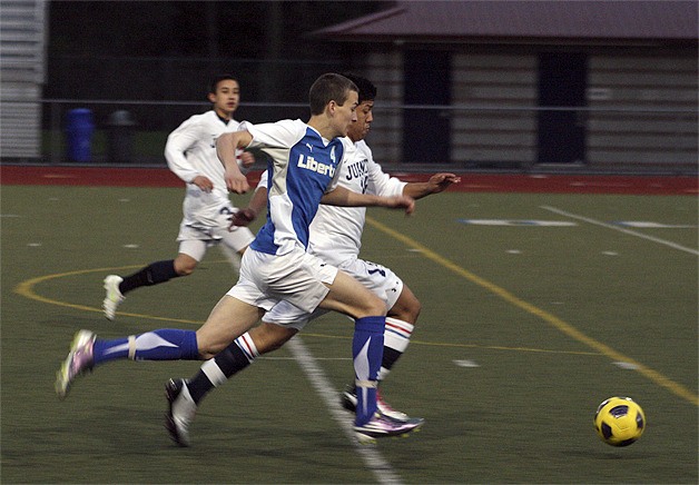 Liberty's Alex Velasquez races a Juanita defender for a ball April 5.