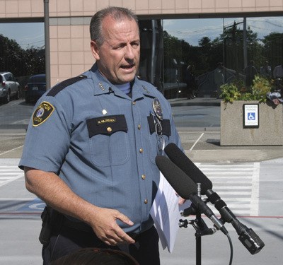 Renton Police Chief Kevin Milosevich addresses the media Thursday in front of City Hall about a cyberstalking that targeted his department and employees.