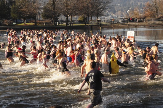 Dozens of swimmers - and runners - braved the cold temperatures and the cold waters of Lake Washington Saturday to welcome in the New Year at the annual Polar Bear Dip at Gene Coulon Memorial Beach Park. Afterward