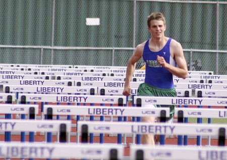 Liberty's Troy Solly runs through the 110-meter high hurdles against Eastlake April 29.