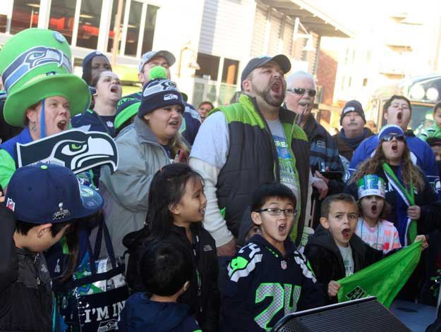 Seahawks fans cheer during the 'Volume 12' Rally Sunday at The Landing.