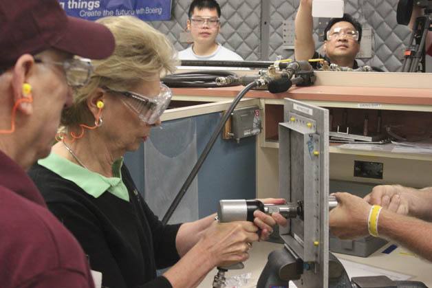 Gov. Chris Gregoire uses a rivet gun Wednesday at an airplane assembly class at Renton Technical College