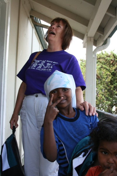 Kindergarten teacher Susan Brumfield visits in coming student Kowsar Aden at the Royal Hills Apartments with a new backpack and some school supplies. Though known for having a high percentage of immigrants