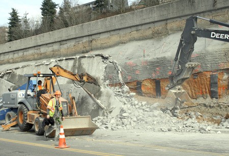 Crews have been removing the retaining wall along Benson Road near City Hall in preparation for moving Benson Road closer to I-405 and then building a bridge for a new I-405 offramp to Talbot Road.