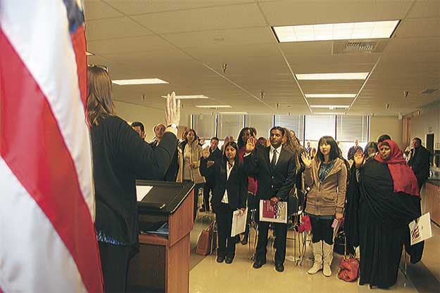 New citizens take the Oath of Allegiance Tuesday at King County elections.