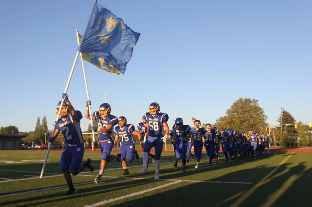 The Hazen Highlander charge onto the field at the beginning of their Sept. 4