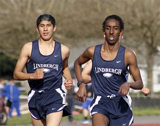 Luke Garcia (left) and Mohamud Abdi run in the 3