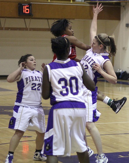 Renton’s Taylor Williams passes out of a group of Highline defenders. The Indians beat the Pirates 34-27 Jan. 11.