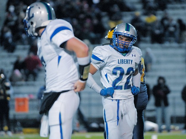 Liberty running back Chandler Jenkins watches