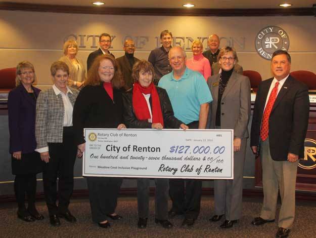 members of the Rotary Club of Renton present the city with a check.