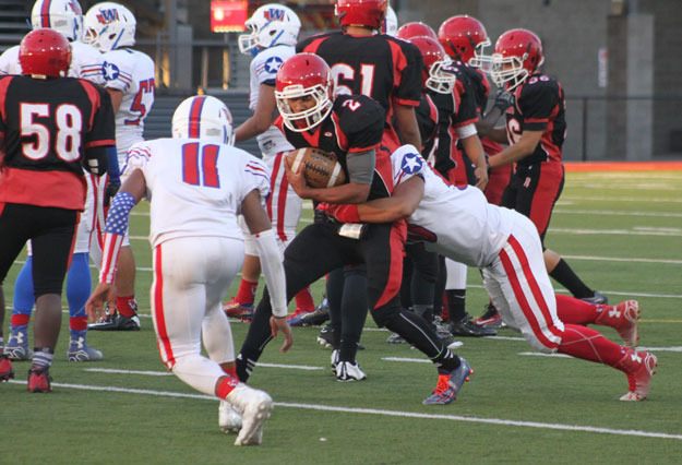 Renton quarterback Drew Olson fights for yards during the first half of Friday's game.