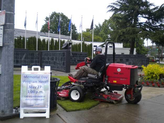 Public Works employee Derrek Prellwitiz gets Veterans Memorial Park ready for Monday's Memorial Day event.