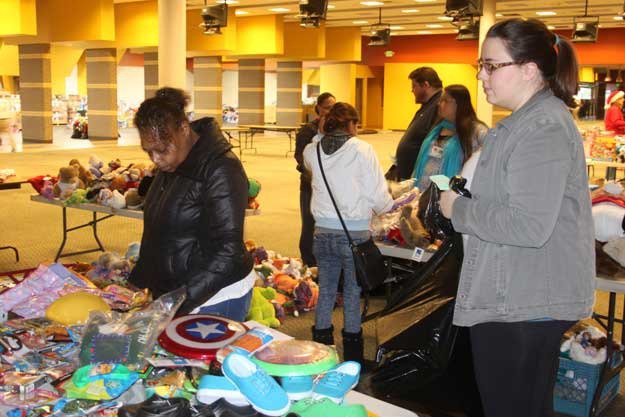 Shonna Williams picks out gifts from the Renton Salvation Army’s toy distribution Wednesday.