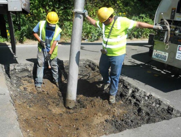 City crews work to repair a sinkhole on Monster Road.