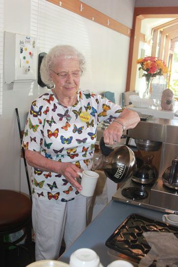 Grace Hanson pours a cup of coffee from her station behind the counter at the Renton Senior Activity Center's coffee shop.