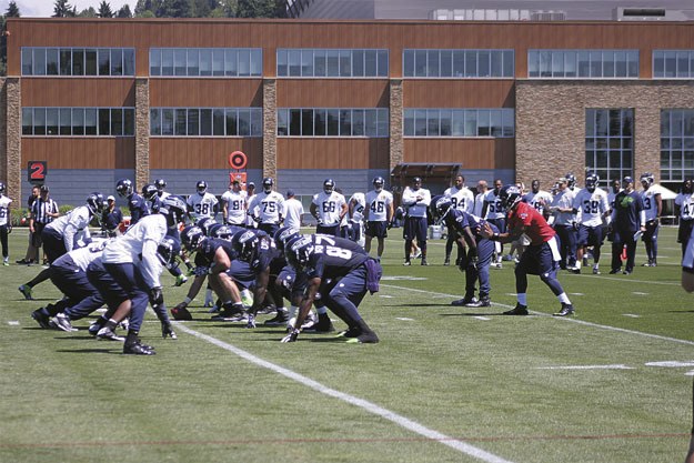 The Seahawks offense and defense lines up against each other during minicamp in June.