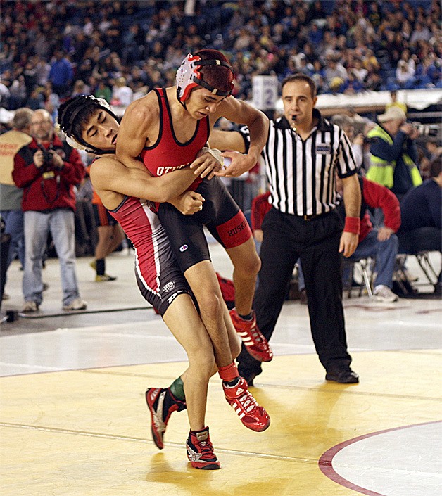 Renton's Aaron Garcia gets ready to slam Othello's Anthony Barrera during a first-round win at the 2A state wrestling meet.