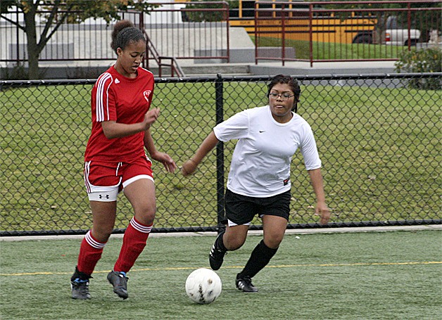 Renton's Justice Perry dribbles past a Tyee defender Oct. 14. Perry had a goal in the Indians' 5-0 win.