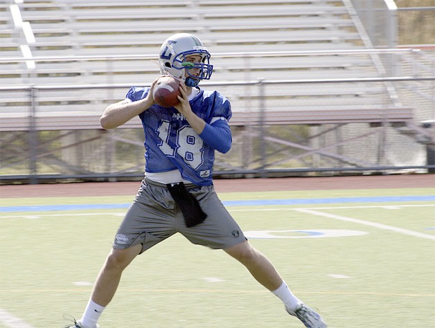 Liberty senior quarterback drops back for a pass at practice.