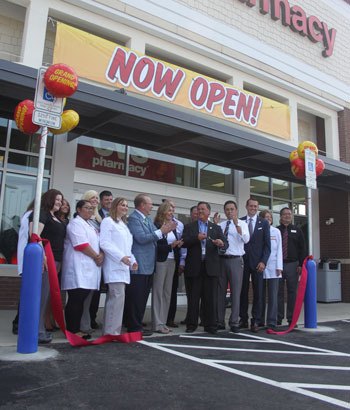 Mayor Denis Law cuts the ribbon at the grand opening of the first CVS store in Washington state