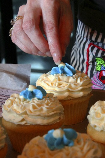 Baker Crystal Roberts puts the finishing touches on cupcakes for a baby shower at Common Grounds Cupcakes. Roberts hopes to compete in Food Network's cupcake challenge.