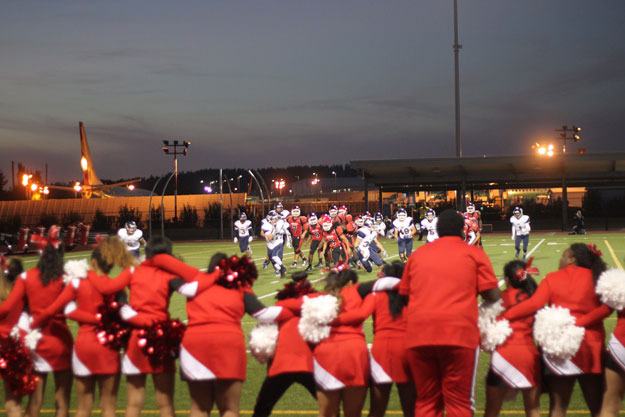 Renton cheerleaders all link arms as the team goes for a 2-point conversion during the Sept. 12 home opener at Renton memorial Stadium.