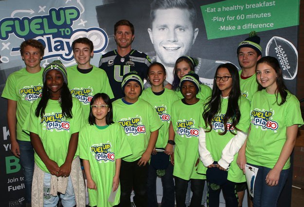 Seahawks kicker Steven Hauschka poses with a group of students following an event last week at McKnight Middle School.