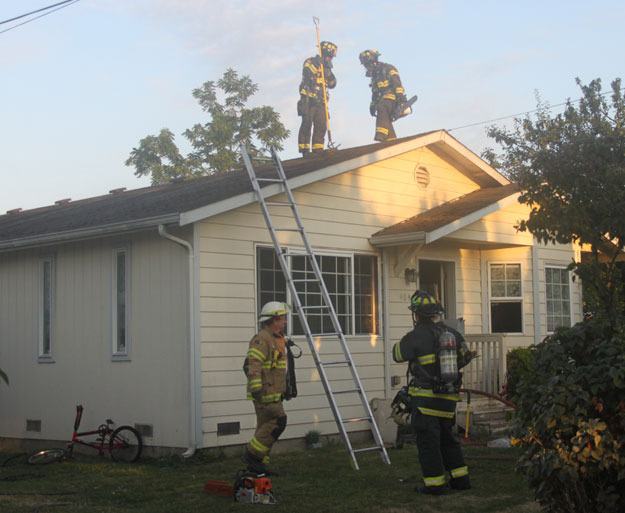 Firefighter work to put out a kitchen fire Wednesday in North Renton.