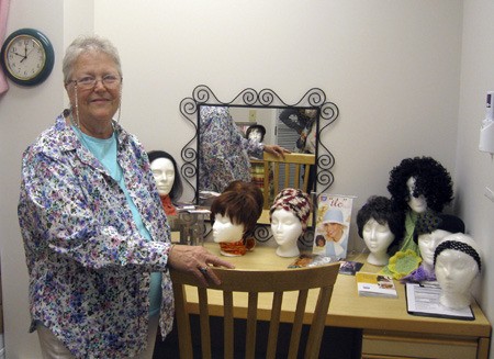 American Cancer Society volunteer Penny Slothower helps women pick out hair pieces in the wig room in the Cancer Resource Center at Valley Medical Center.